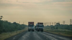 Freight truck driving across a major highway route of the Kenya China Highway Project.